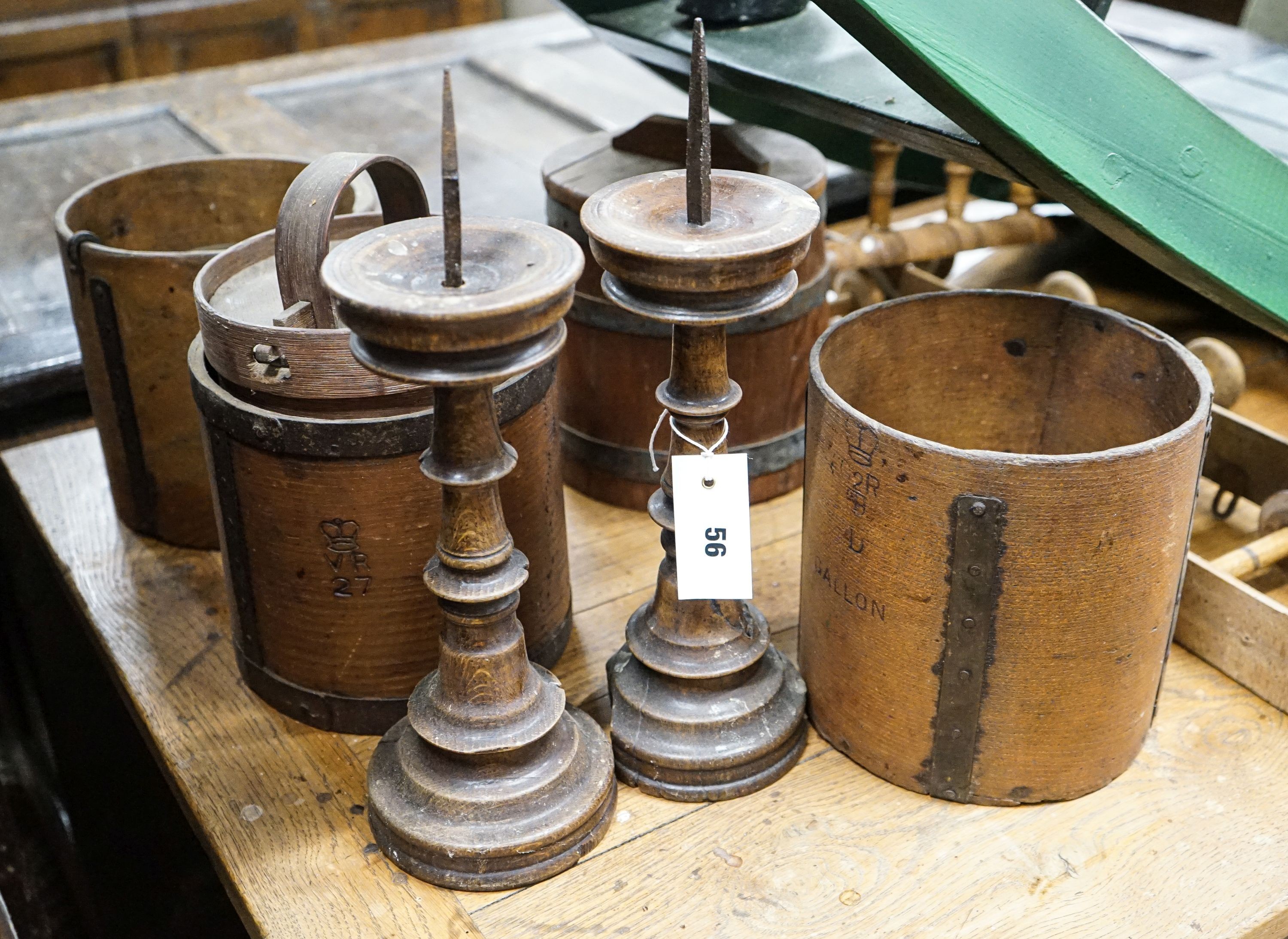 Six assorted treen measures and butter pails, a pair of pricket candlesticks, height 37cm and three faux bamboo coat hooks